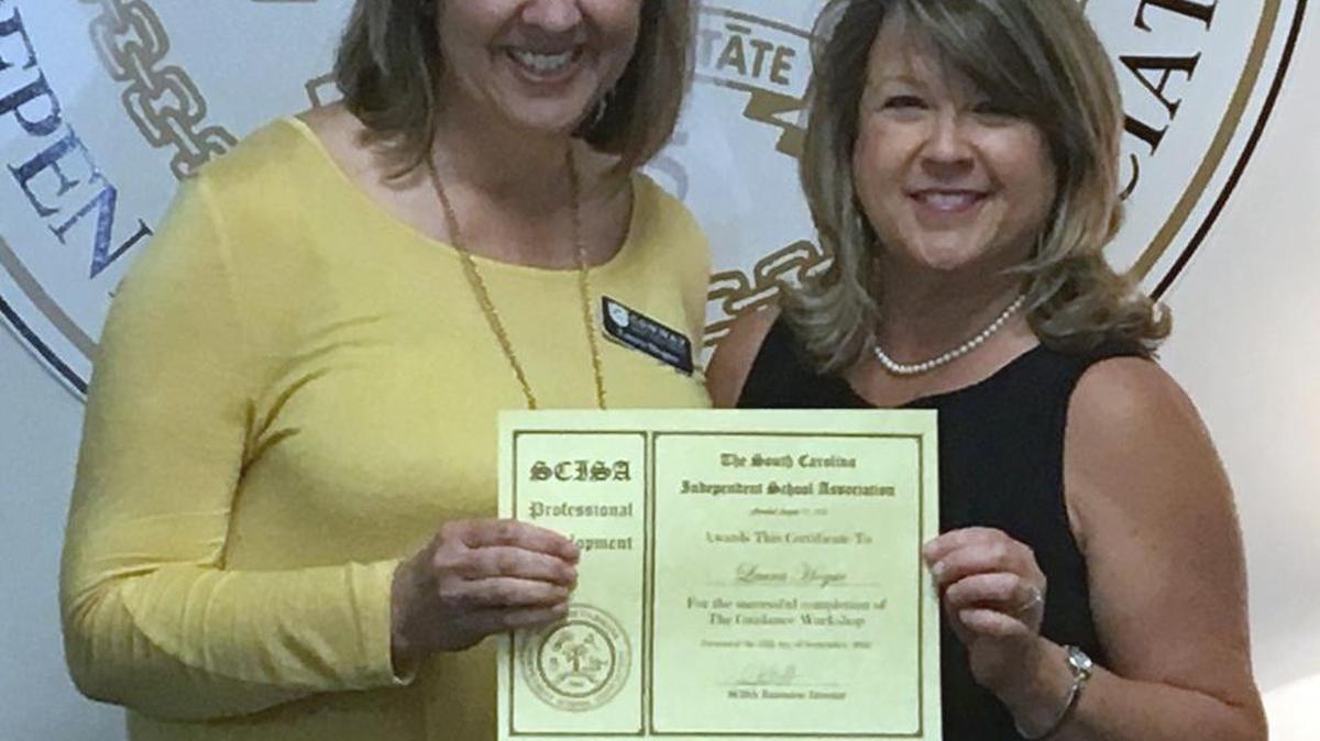 Laura Hogue, left, on the staff at Conway Christian School, receives her certificate of completion for attending the South Carolina Independent School’s guidance workshop from Sally Faulling, administrative guidance workshop facilitator and administrative assistant at SCISA.