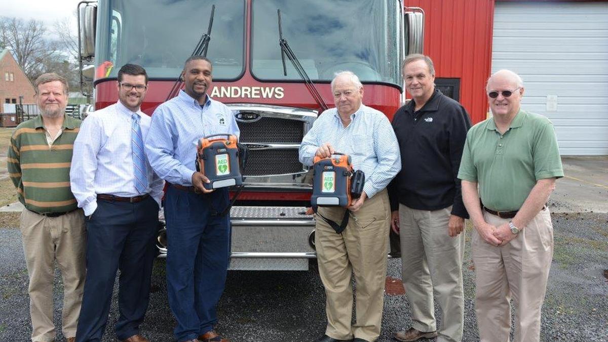 Pictured from left are Andrews Rotary Club members Alex Hemingway and Ned Hemingway, Rotary president Mack Burgess, Andrews Fire Chief Bobby Barrineau, and Rotary Club members Sel Hemingway and Tommy Branyon with two of the AEDs the group recently donated.