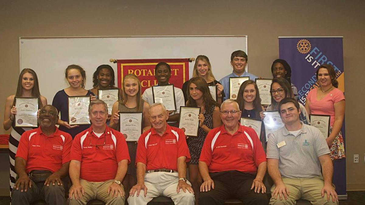 (New inductees, back left to back right; Claire Chapman, Kelsea Jones, Raygan Moore, Morgan Kranz, Jasmine Holmes, Alyssa Wagor, Abby Danziger, Griffin Amberson, Lucia Zats, Lovenia Williams, Kira Lloyd, and Shakeria Cuthbert. Members of the Rotary Club of Carolina Forest Sunrise and the Rotaract advisor, front left to right; Ralph Jones, Porter Medley, charter club president Dr. Robert 'Bob' White, Past District Governor Dr. Robert 'Bob' Squatriglia, and Rotaract advisor Daniel Hucks.)