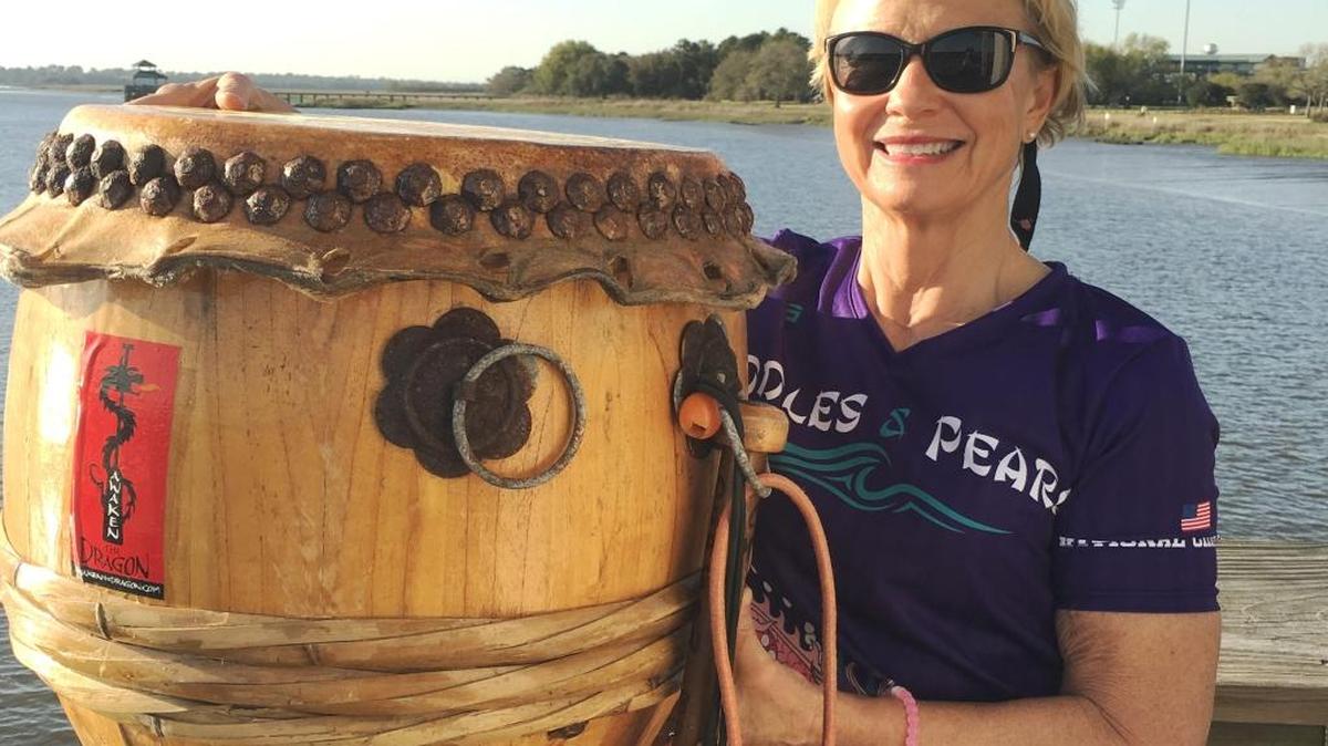 Barbara Moyer with a drum on a dragon boat. Moyer of Myrtle Beach is preparing for an exciting adventure in Adelaide, Australia that begins with paddling a dragon boat in the World Championship Dragon Boat races.