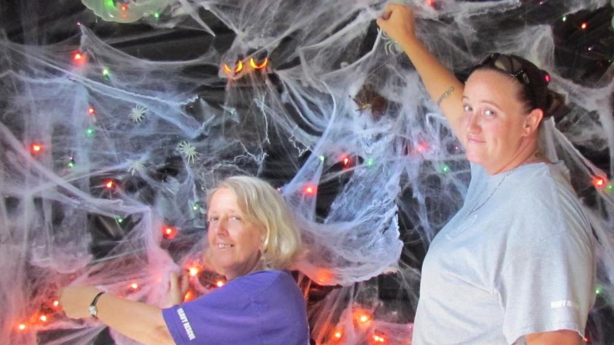 Elaine Moskowitz (left) and Miranda Walcott, both staff firefighters/EMTs at Grissettown Longwood Fire & Rescue in Ocean Isle Beach, N.C., send warning glances to would-be visitors to the firehouse’s annual Haunted Trail.