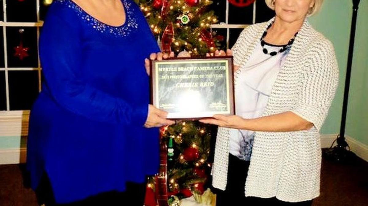 Vicki Price, left, Myrtle Beach hCamera Club competition coordinator, stands with 2015 Photographer of the Year Cherie Reid.