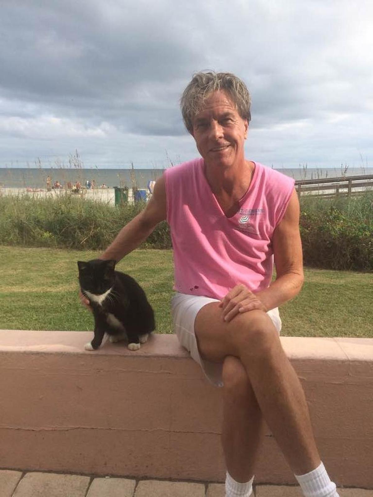 Luke Goude pictured with his cat, Whitesox.