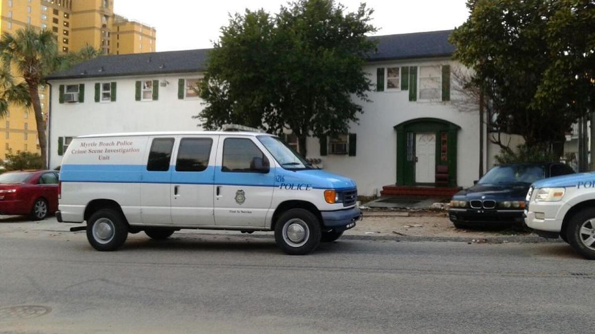 Myrtle Beach police vehicles sit outside near a motel/apartment building where a person was shot Thursday.