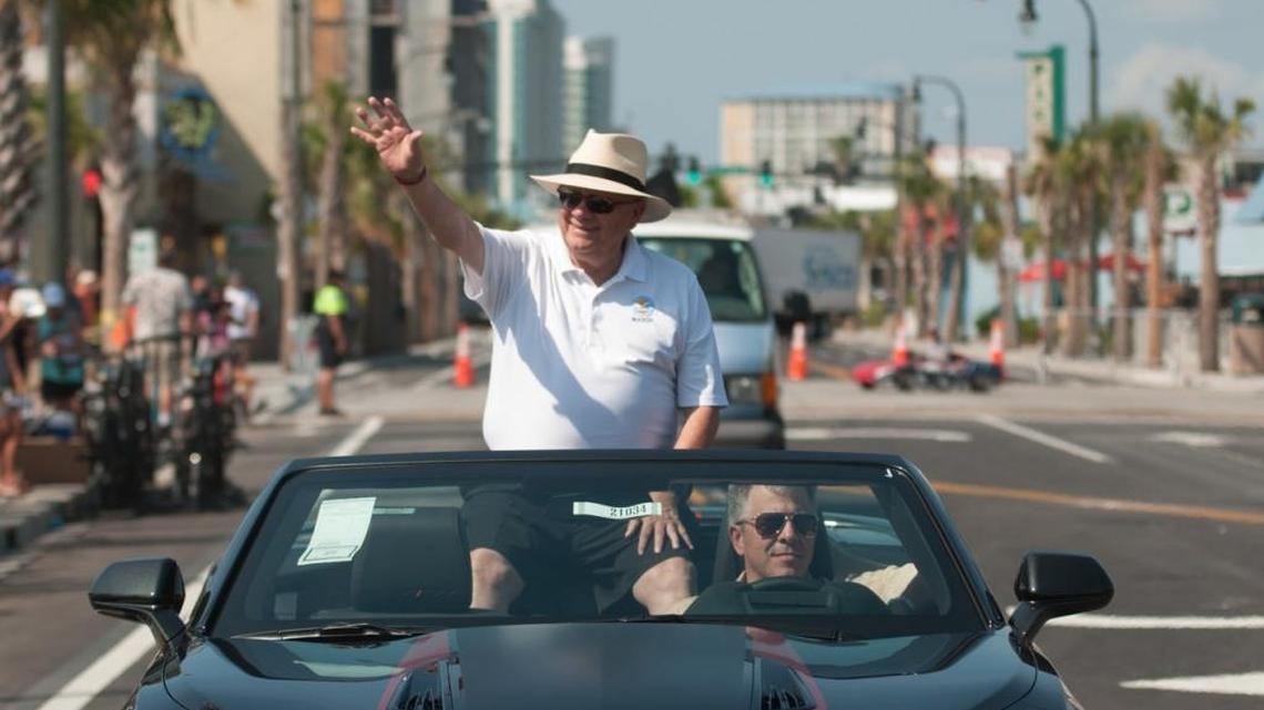 Mayor John Rhodes waves to the crowd as he passes in the Sun Fun parade.