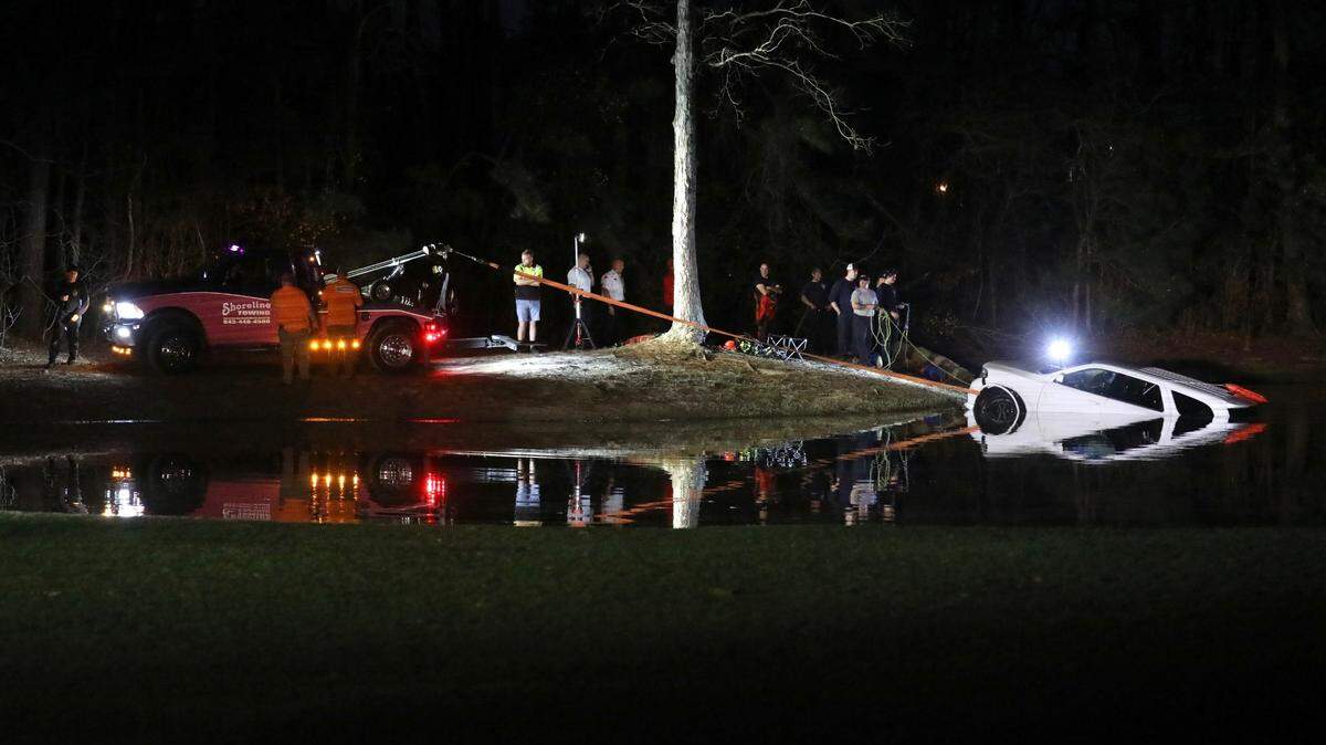 Crews from Myrtle Beach Fire and Horry County Fire Rescue work to pull a car out of the pond on the fourth hole of the Whispering Pines Golf Course. A women and a child were rescued by personnel at the scene. Feb. 28, 2023.