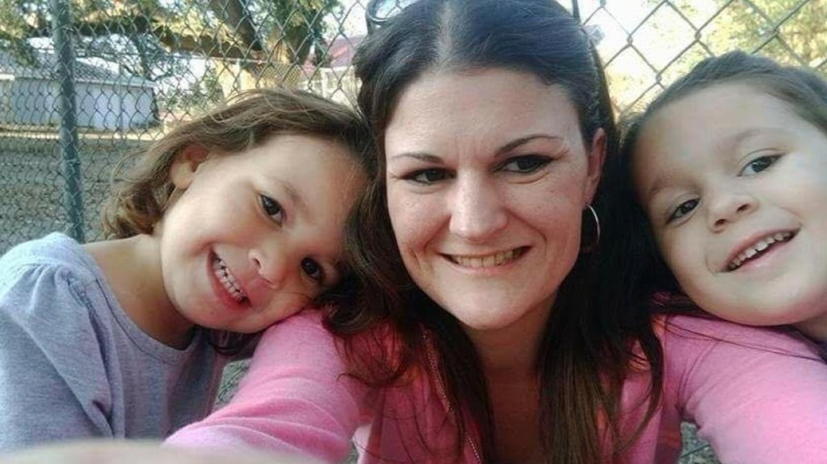 Brooke Koluch (center) takes a photo with her two daughters.