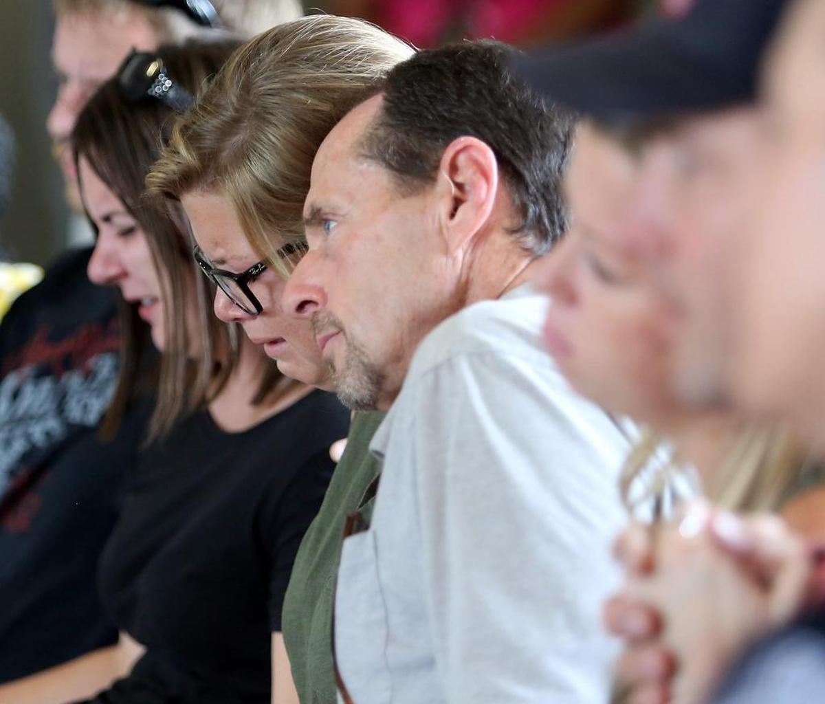 Family and friends held on to one another during the announcement of the arrest of a man charged with killing two women at the CresCom Bank off 16th Avenue in Conway at a press conference on Aug. 23, 2017.