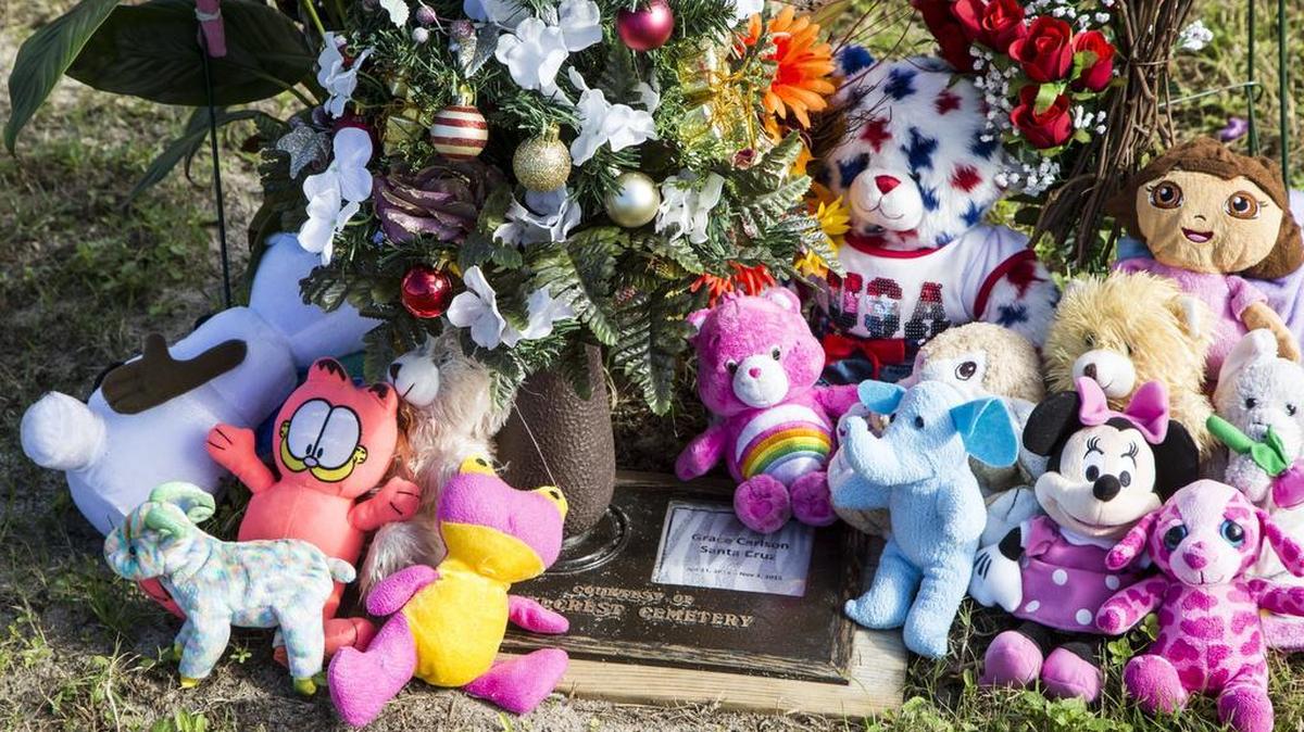 Grace Carlson Santa Cruz' grave is adorned with stuffed animals and Christmas decorations. Services are held to honor Baby Boy Horry on the seventh anniversary of the infant that was found dead in shopping bag in a ditch. This year mourners also honored Baby Grace Carlson Santa Cruz who's body was found last month after her mother said she was lost to the waters of Socastee Swamp. Dec. 4, 2015.