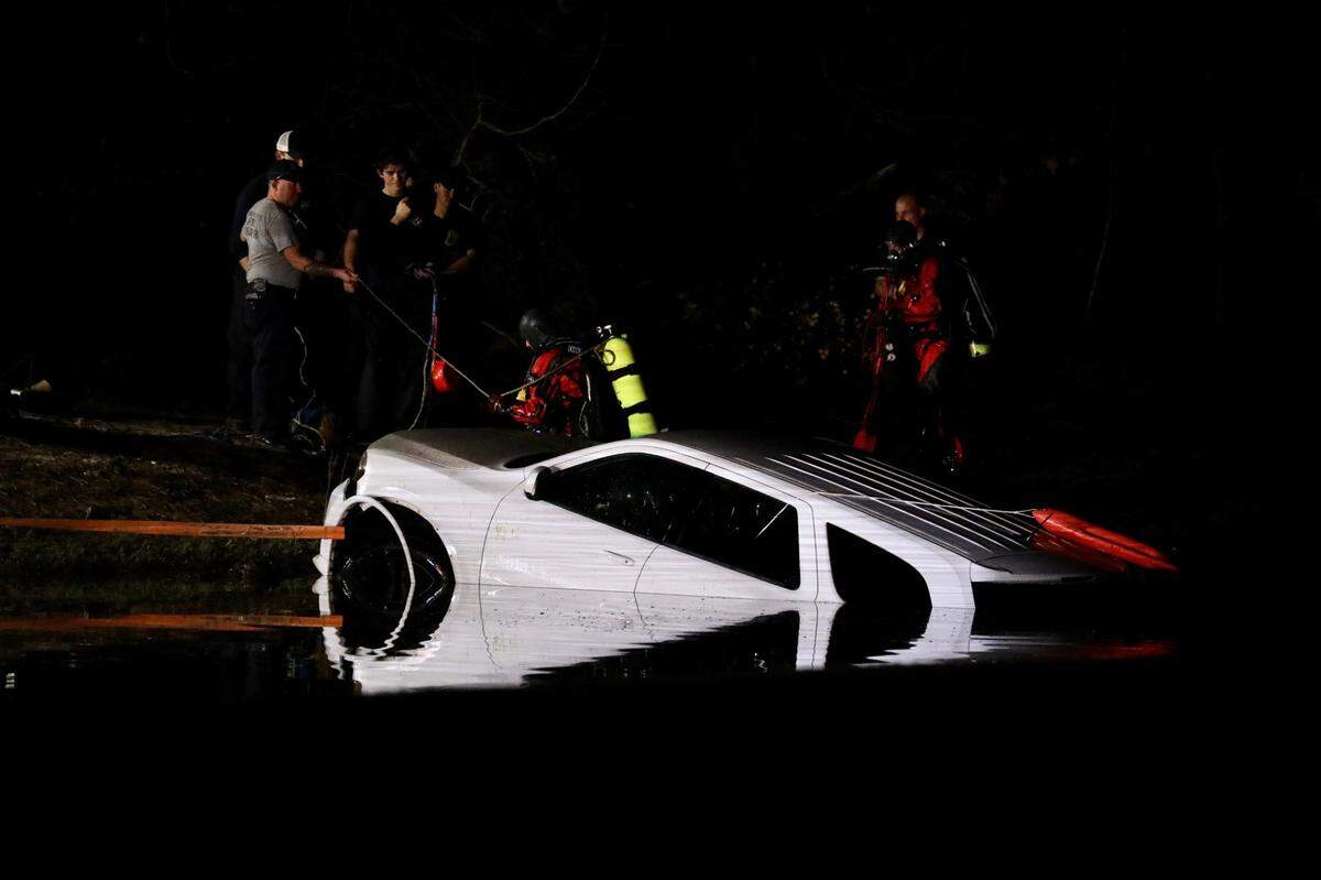 Crews from Myrtle Beach Fire and Horry County Fire Rescue work to pull a car out of the pond on the fourth hole of the Whispering Pines Golf Course. A women and a child were rescued by personnel at the scene. Feb. 28, 2023.