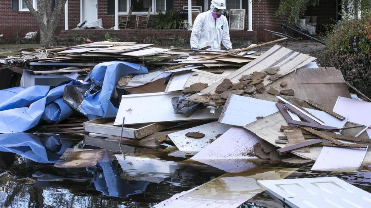 Americorps volunteers from across the United States assist in mucking out the home of Joey Tyler on Sherwood Drive on Monday. The many volunteers that are helping with flood victims are organized under the Waccamaw VOAD (Voluntary Organizations Active in Disasters.) October 1 2018.