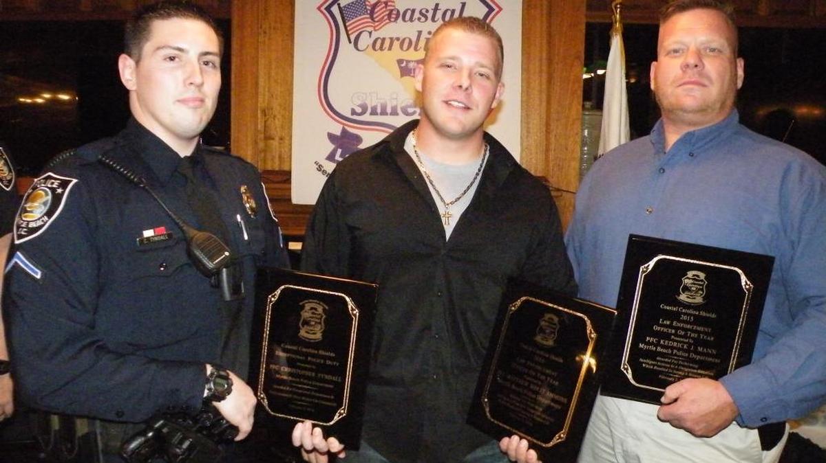 Myrtle Beach police officers Christopher Tyndall, Rhett Ammons and K.J. Mann (from left) are recognized by the Coastal Carolina Shields on Tuesday night for outstanding performance while in the line of duty.