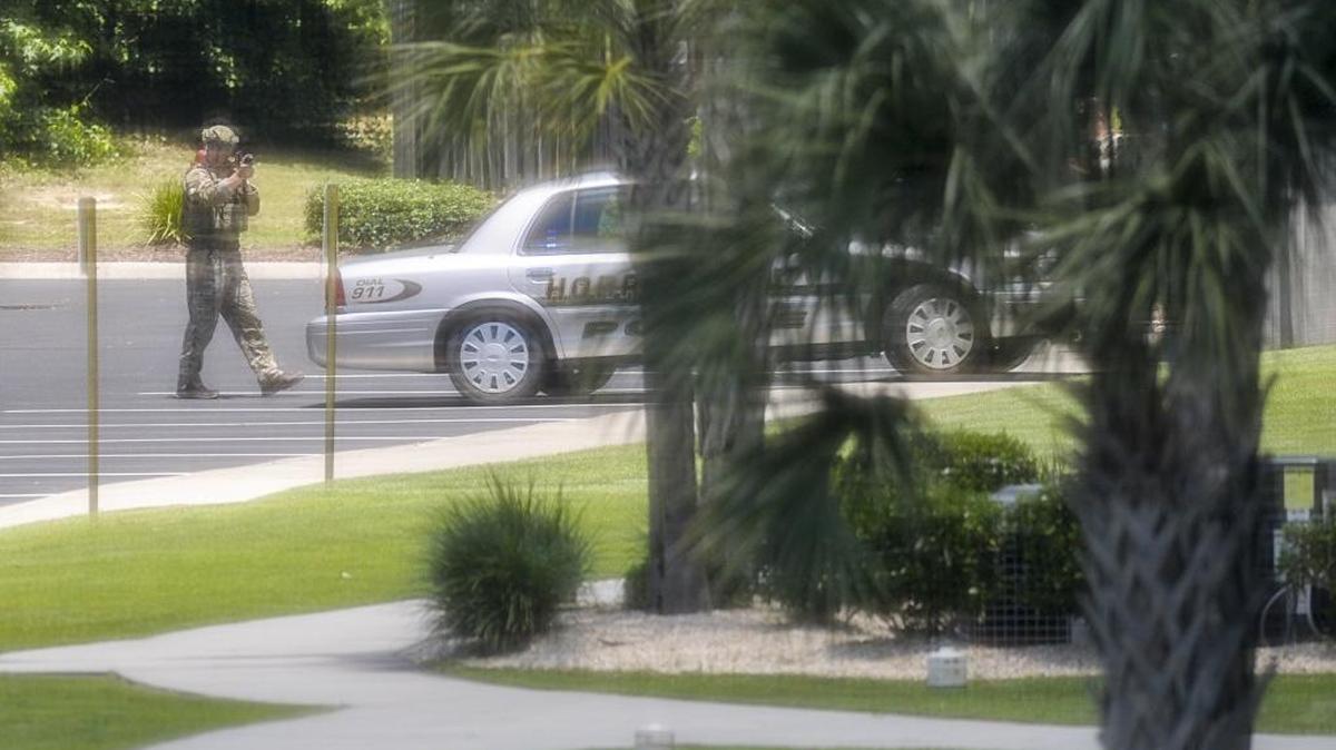 Horry County police are involved in a standoff at a home off of Waypoint Ridge Avenue in the Carolina Yacht Landing subdivision in Little River (as viewed through a screened window in a neighboring residence.) The suspect is wanted for assault.
