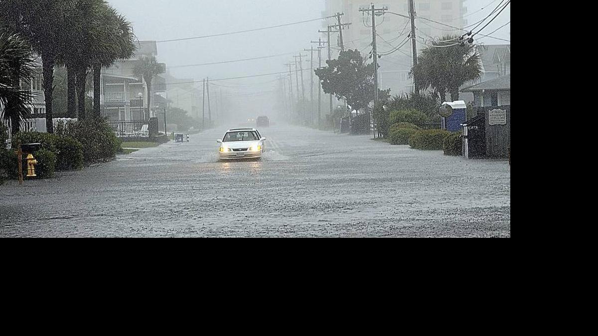 
A car drives south on a flooded Ocean Boulevard after it drove past barricades warning of the high water, Sunday morning. Heavy winds, rains and a high tide left the water no place to drain to. Tropical Storm Ana made landfall in North Myrtle Beach at 6 a.m. Sunday morning and by mid-morning low-lying streets were flooded and the surf was pounding the Cherry Grove Fishing Pier.
