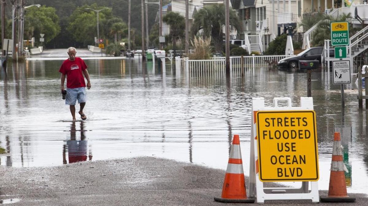 Tom Walker wades from his home on 53rd Avenue in North Myrtle Beach. Residents of the Cherry Grove section of North Myrtle Beach continue to deal with flooding due to repeated King Tides. Many streets are flooded causing damage to low lying homes and structures.