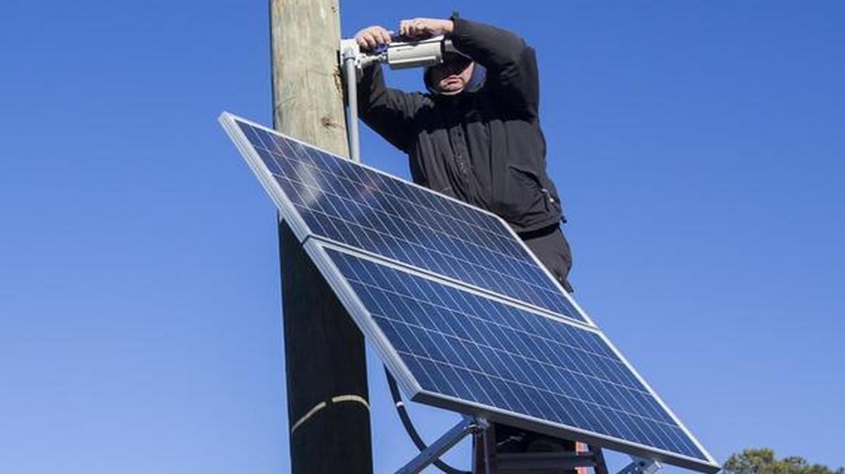 
Gary Brookshire with Tyco Integrated Security places a camera on a pole at the Danny Knight Boating Facility at Red Bluff in January. Horry County hired Tyco after officials said the previous company failed to live up to its contract for boat landing camera installations.
