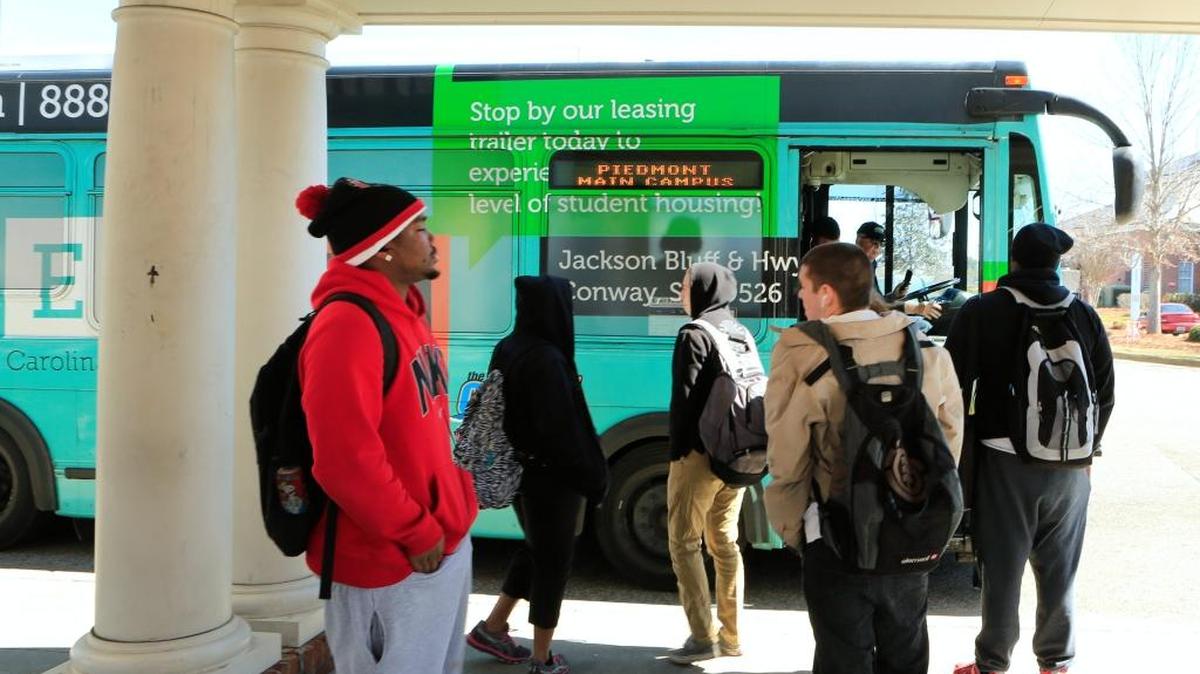 CCU students wait to board a Coast RTA bus on campus.