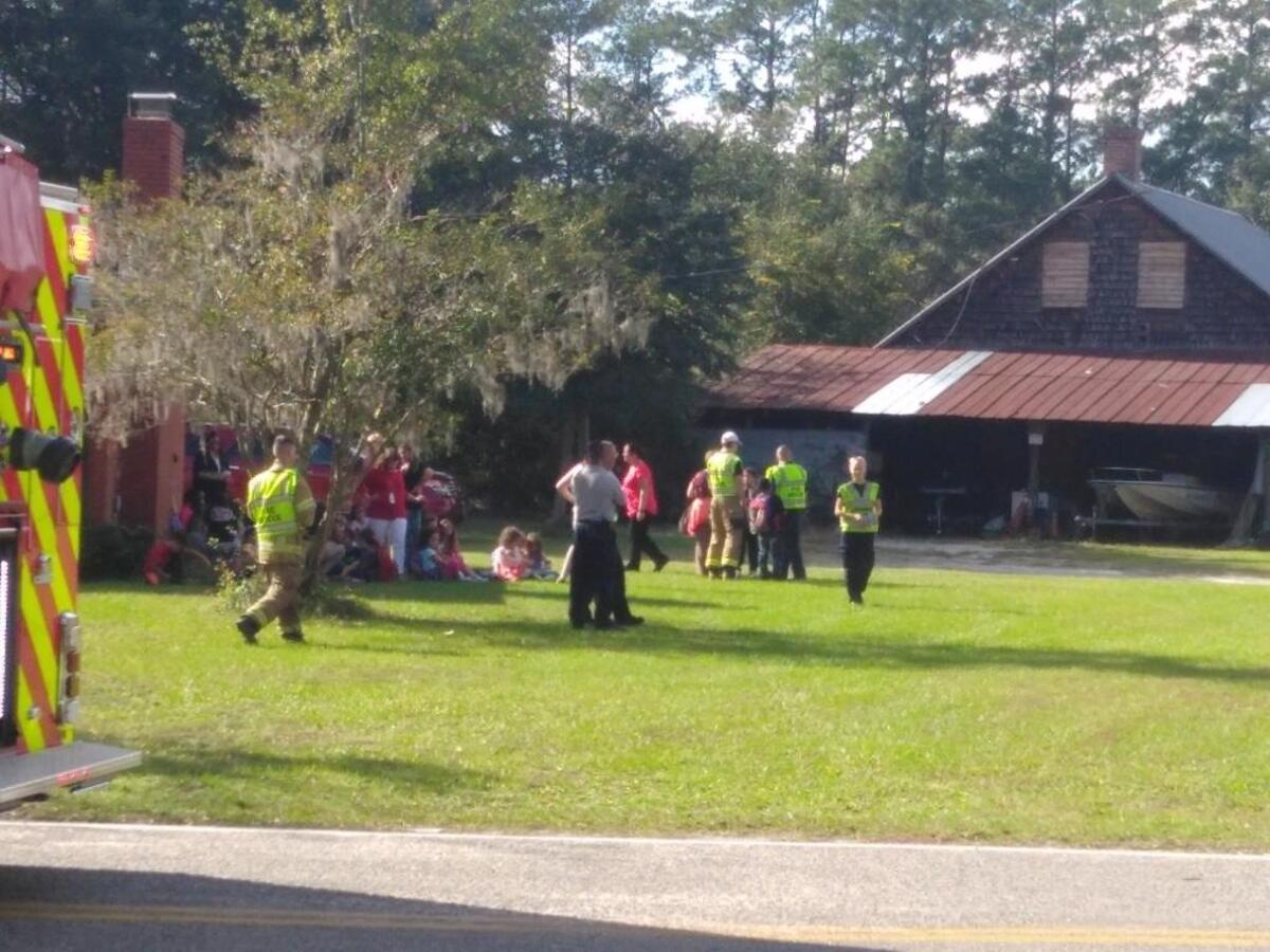 Two students were injured after a bus slid into a ditch near Waccamaw Elementary School Thursday.
