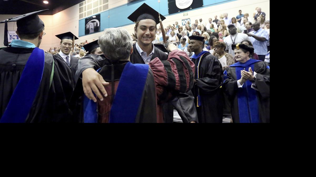 
Abiding with tradition, the faculty applaud and embrace the graduates at the end of the first of four separate commencement ceremonies as students from the E. Craig Wall Sr. College of Business Administration at Coastal Carolina University graduate in the HTC Center on Friday. The graduation ceremony was divided according to colleges and relocated from Brooks Stadium on Saturday. The reason for the multiple events is the threat of Subtropical Storm Ana. All the ceremonies are to be held at the HTC Center located at 104 Founders Drive on the CCU campus.
