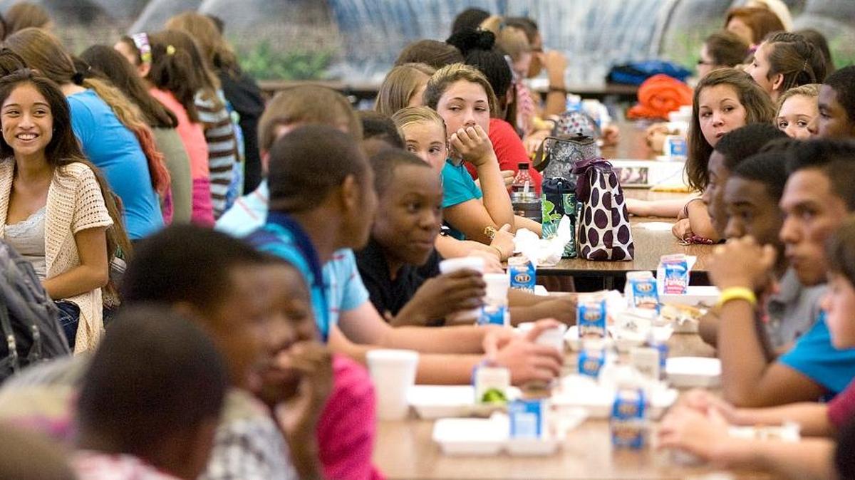 Girls laugh in the lunch room at Whittemore Park Middle School. The Horry County Schools finance committee met Wednesday to discuss an alternative way to save $3 million after the joint finance and human resources committee motioned last week to add two students to middle and high school classes over two years.
