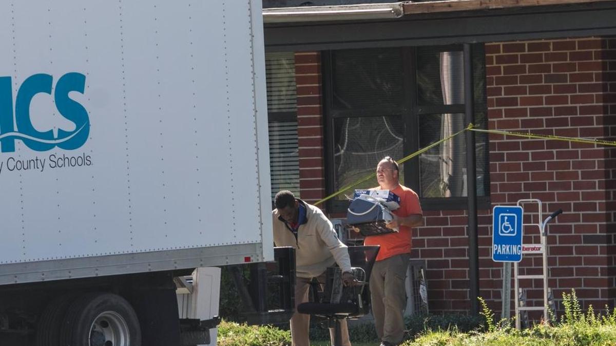 Workers remove items from the storm damaged Horry County Schools Transportation building behind Whittemore Park Middle School after Hurricane Matthew on Tuesday, Oct. 11, 2016.