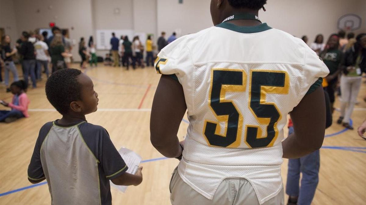 South Conway Elementary student Elijah Parker talks with his mentor Naseem Dewitt of Myrtle Beach High during a party celebrating the program Mentoring Through Success Friday morning at South Conway Elementary School in Conway.