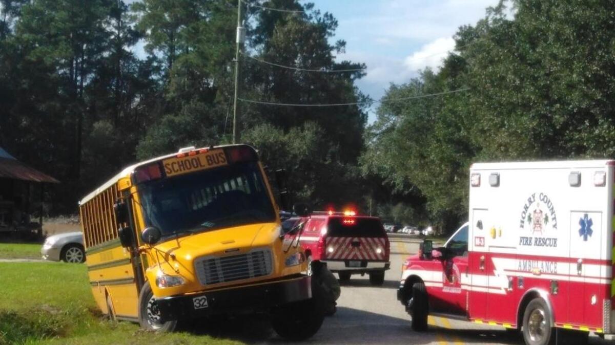 Two students were injured after a bus slid into a ditch near Waccamaw Elementary School Thursday.