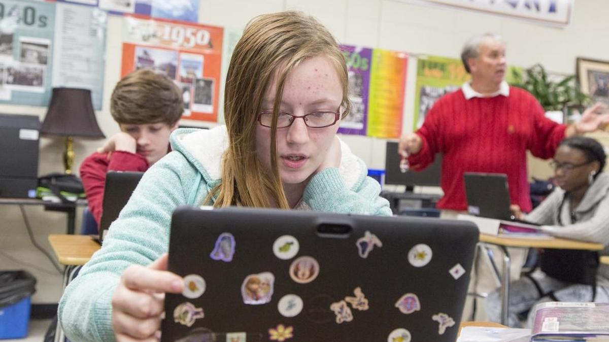 Elizabeth Paul, an 11th grader at Loris High School, works on her decorated tablet while Honors English Teacher, Danny McPherson gives instructions in the background. Horry County Schools students didn’t meet the college-ready ACT benchmark but did score higher than state averages.
