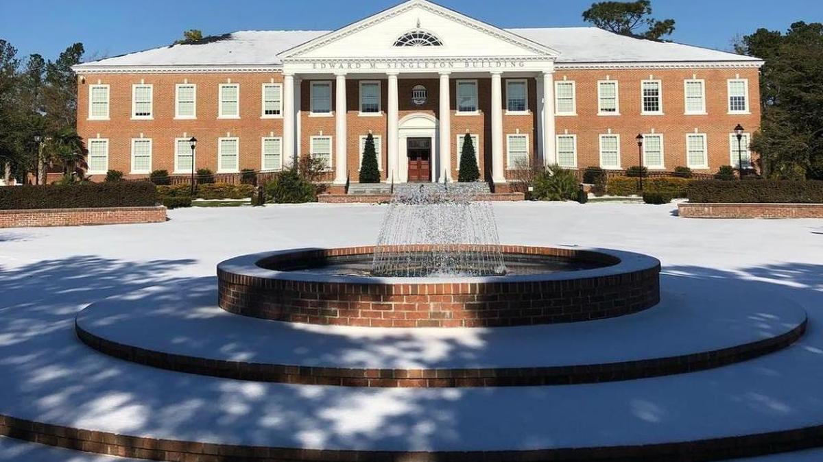 Snow covers the ground in front of the Edward M. Singleton Building on the Coastal Carolina University campus last week.
