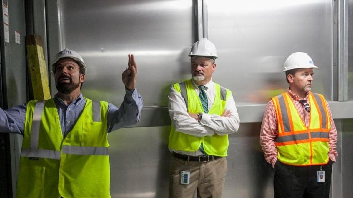 Horry County Schools Executive Director of Facilities Mark Wolfe (right) and Superintendent Rick Maxey (center) stand by as FirstFloor Energy Positive CEO Robbie Ferris (left) gives a tour of Ten Oaks Middle School on Thursday, Sept. 22, 2016.