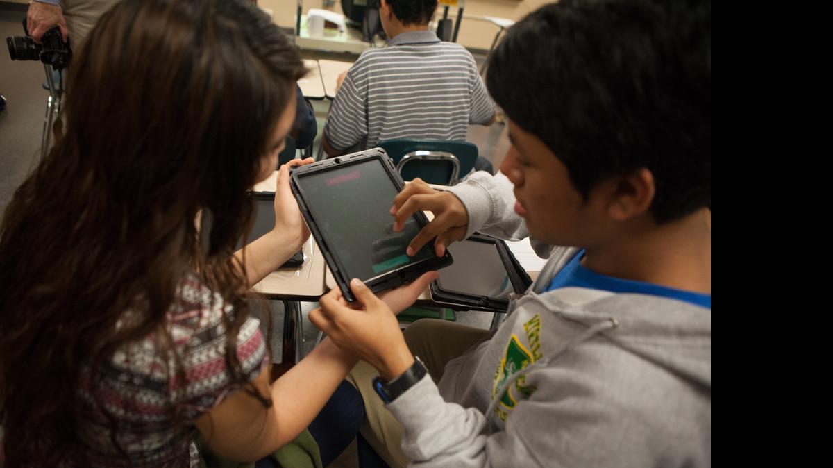 
Alisson Amaya and Christopher Armijo start up a new iPad for the first time. Eighth graders at Myrtle Beach Middle School were the first group of Horry County students to receive iPads in January 2014. 
