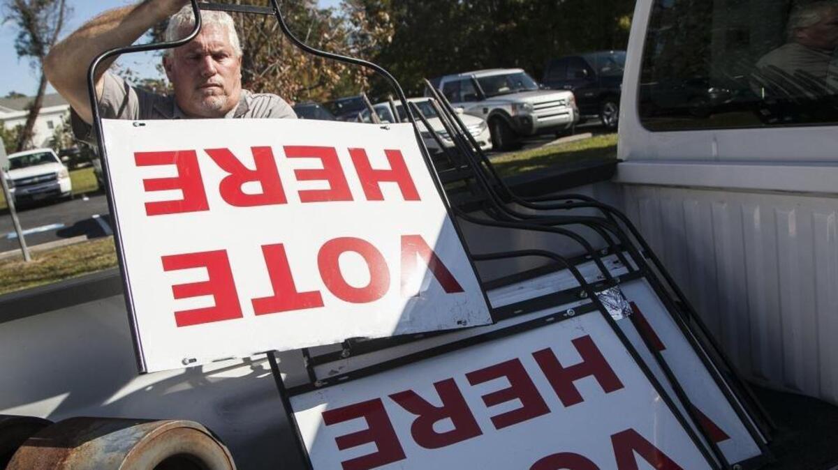 Horry County Maintenance workers Byron Boyd(pictured) and Tim Watkins deliver signage and voting machines to the polling precincts in advance of Tuesday's elections . November 6, 2017.