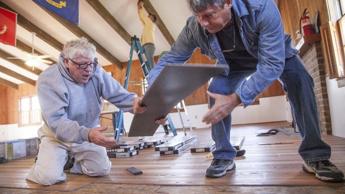 Douglas Vining and Gary Lewis replace destroyed flooring at American Legion Post 40. Members and volunteers worked to refurbish their building following October 2016 flood damage in Socastee. The veteran’s organization received donations from many sources around the area including a large grant from Home Depot stores.