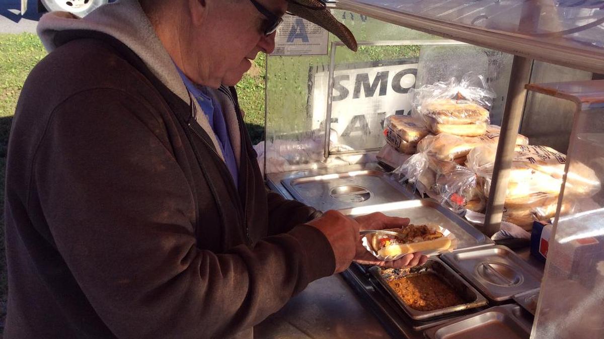 Mike Mathis of Buster Brown Hot Dogs fixes a chili and slaw dog for a customer. Mathis is the only mobile food vendor in Horry County other than ice cream trucks. He considered buying a food truck, but changed his mind because he didn’t think it was financially feasible. Six months after county officials changed the law to allow food trucks, not one is rolling in Horry.