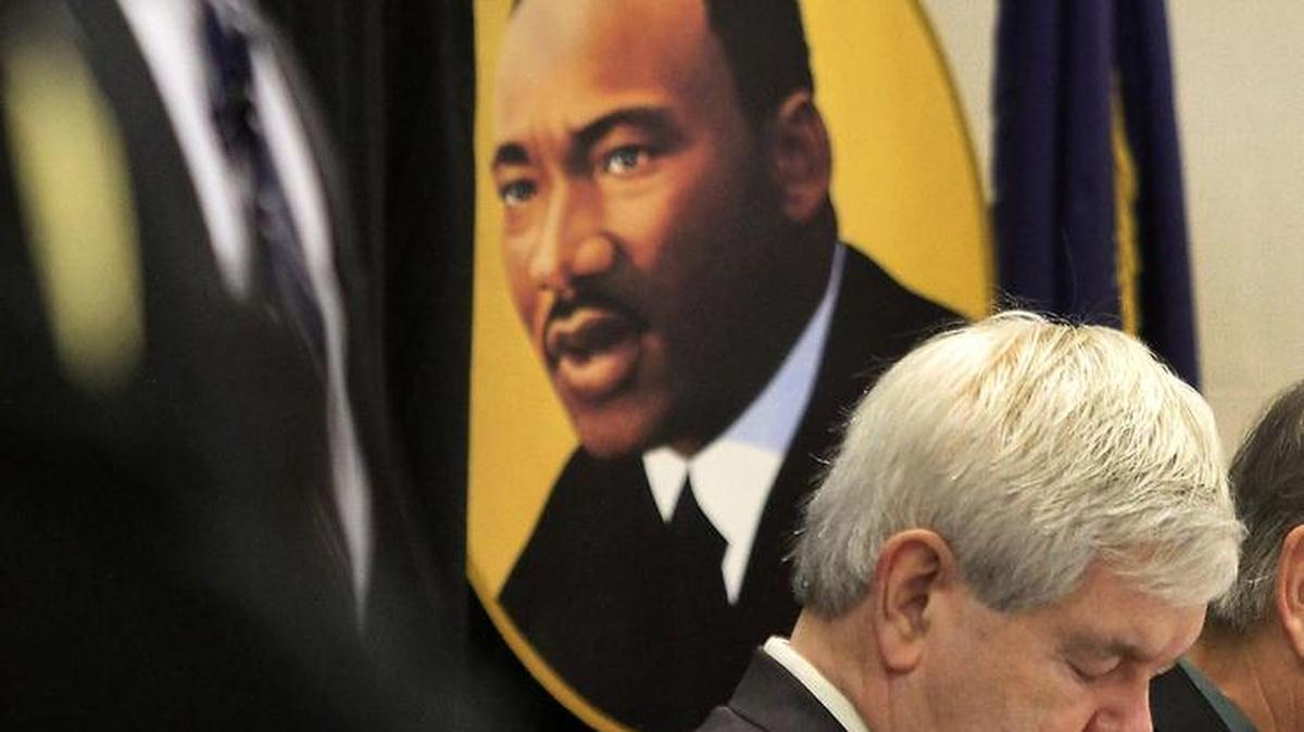 Presidential candidate Newt Gingrich bows his head for the invocation during the 2012 Martin Luther King Jr. celebration breakfast in Myrtle Beach.