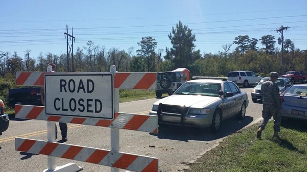 
Horry County Police and National Guardsman patrol the entrance to Waccamaw Drive off U.S. 501 to allow residents in, but keep looters out of the flood zone.
