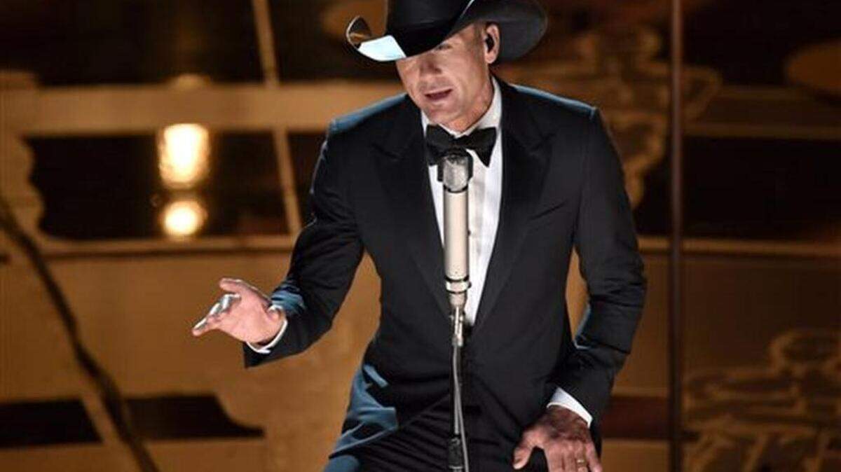 FILE - In this Feb. 22, 2015 file photo, Tim McGraw performs at the Oscars at the Dolby Theatre in Los Angeles. McGraw will hold a concert for Sandy Hook this summer and dedicate all of the proceeds to an organization aimed at protecting children from gun violence. He will perform at the XFINITY Theatre in Hartford, Connecticut, on July 17.