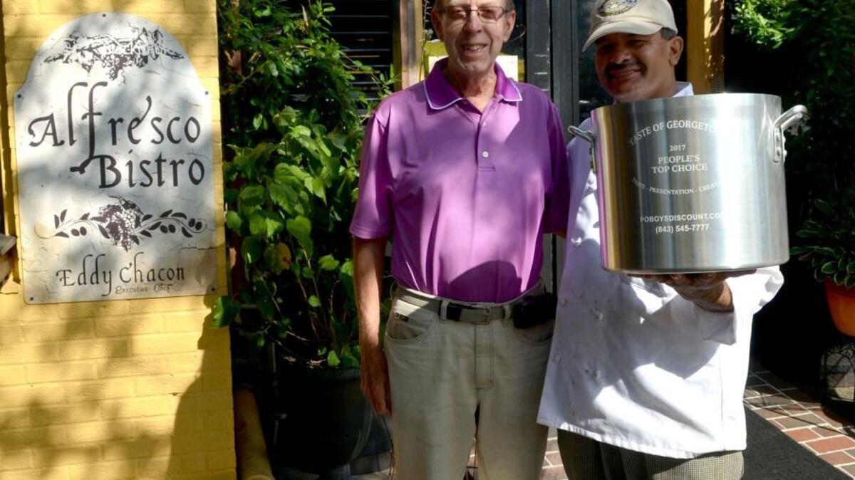 Pictured from left are Dick Clute, Family Justice Center Board Chairman, and Eddy Chacon, owner and executive chef at Alfresco Bistro.