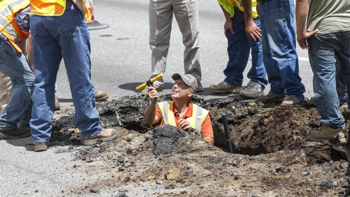South Carolina Department of Transportation personnel investigate a sink hole in the southbound lane of Hwy. 17 Bypass near the construction site at the Holmestown Road intersection.