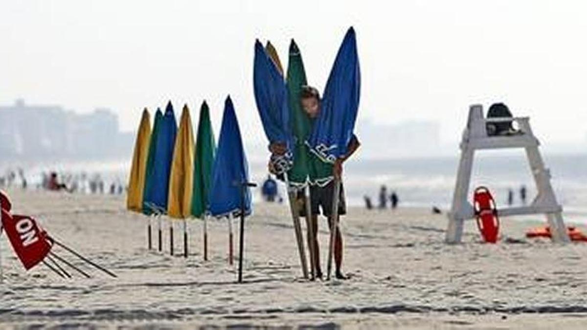 Lifeguards set up their station, chairs and umbrellas near Pier 14 in Myrtle Beach in this Sun News file photo.