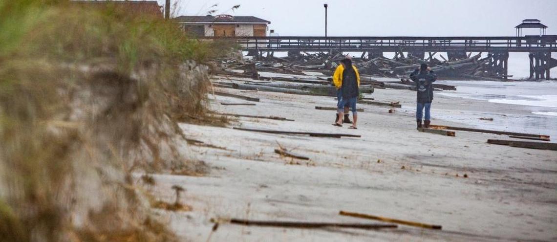 People collected wood washed ashore from the Springmaid Pier as the eye of Hurricane Matthew passed over the Grand Strand.