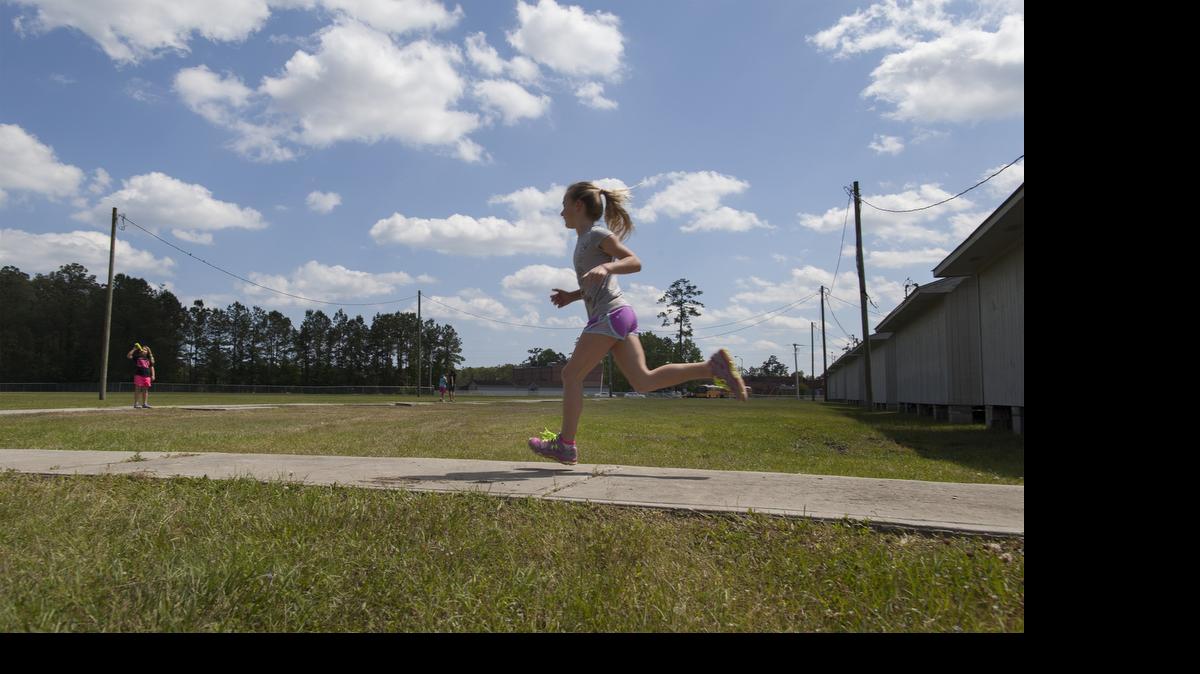 
Sammy Christenson, 9, runs along a path as part of the Girls on the Run after school program Tuesday at St. James Elementary in Myrtle Beach. Girls on the Run Grand Strand is a nonprofit that welcomes young girls for after-school gatherings designed for fitness and socializing. They meet twice a week in 12-week-long sessions ending with the Girls on the Run Grand Strand 5K race Saturday. 
