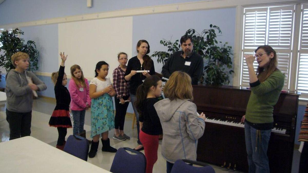 At Trinity Church in Myrtle Beach, Ashley Sosis speaks pianoside during “Pedals, Pipes, and Pizza” on a Saturday morning in February, in a workshop by the American Guild of Organists, Grand Strand Chapter, for young piano players.
