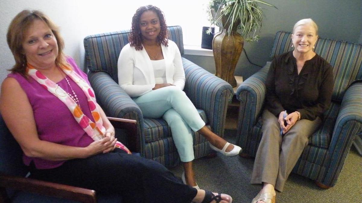 Relaxing in a meeting area outside the counseling office of the Family Justice Center in Horry County are (from left) case manager Linda Collins, counselor Veronica Akong and co-executive director Vicki Bourus.