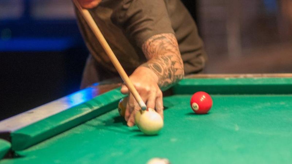 Tom Slava shoots a game of pool at Remedies Bar. Horry County considered closing bars at 2 a.m. but instead will regulate business licenses.