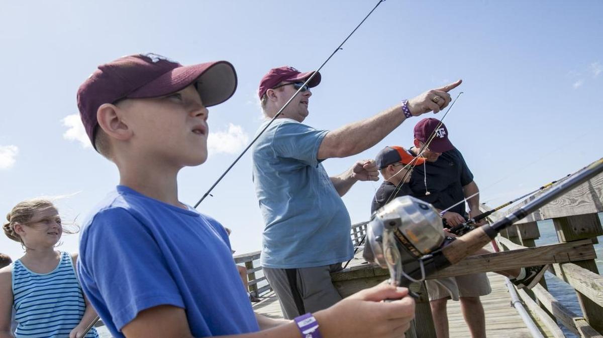 Abraham Delange and Brent McCord, brothers-In-law, take their children fishing at Cherry Grove Pier on Saturday, June 18 2016.