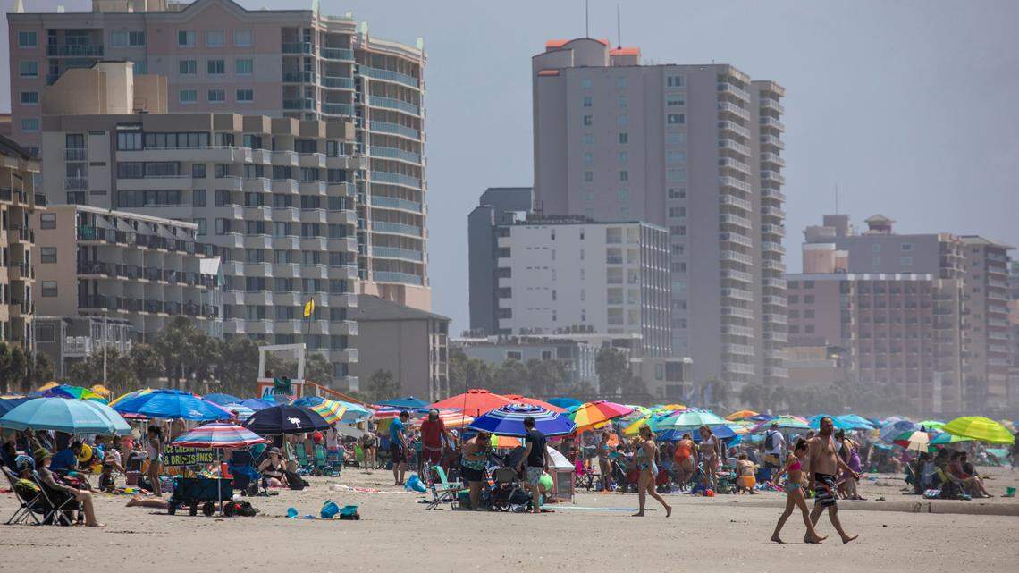 Thousands of visitors pack the beach in North Myrtle Beach just steps away from the relative quiet of Atlantic Beach. June 13, 2022.