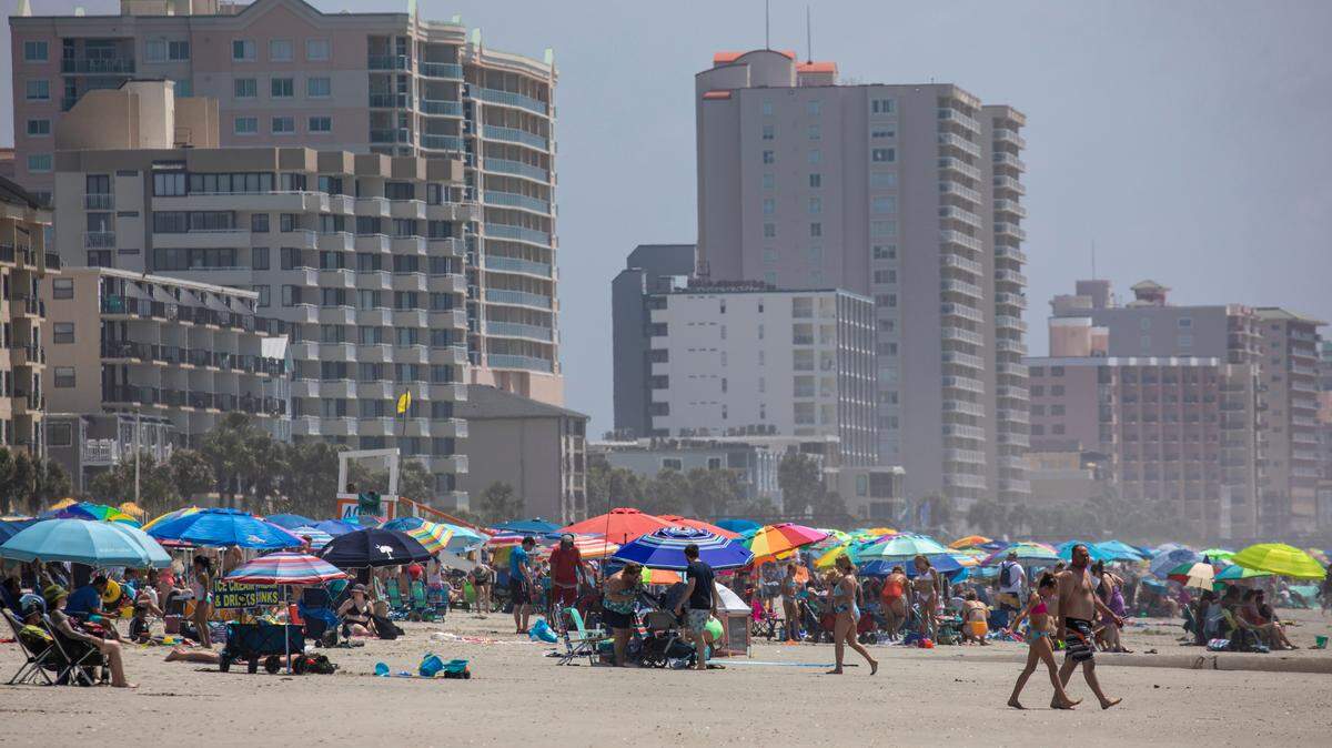 Thousands of visitors pack the beach in North Myrtle Beach just steps away from the relative quiet of Atlantic Beach. Atlantic Beach, the small historically black beach town sandwiched between sections of North Myrtle Beach, is undergoing a revitalization according to town manager Benjamin Quattlebaum. New homes are being constructed and oceanfront lots are being marketed to hotels and resorts. June 13, 2022.