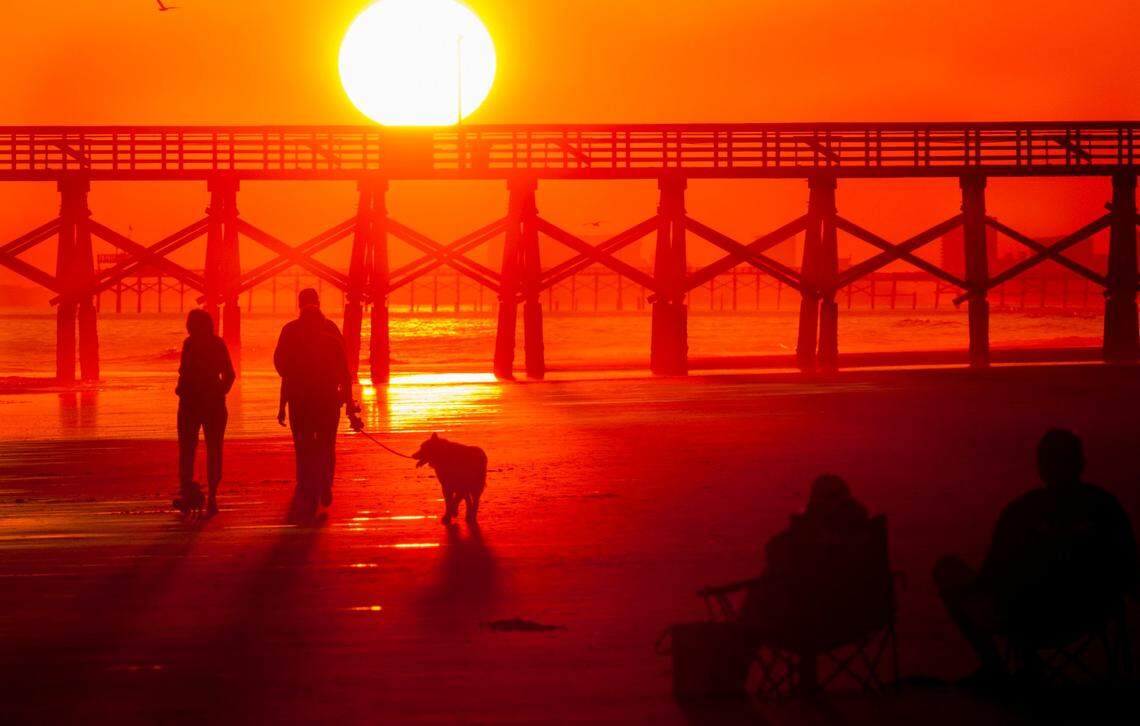 Vacation rental companies saw spikes in interest for pet-friendly lodging in the Carolinas as people travel shorter distances but stay longer. Above, beachgoers enjoy a November sunset in the Cherry Grove section of North Myrtle Beach on Friday, Nov. 18, 2016.