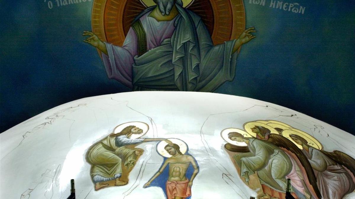 Below a canvas of Jesus, iconographer Alex Margini touches up the angels gathering around Jesus getting baptized by Saint John at Saint John the Baptist Greek Orthodox Church in Myrtle Beach on Wednesday, Oct. 6, 2004. The halos are painted with gold. Margini and Panos Kontos have travelled from their home in Greece to complete the iconography on two wings of the church. They plan on returning in December to finishes the last wing of the church. Kontos has been painting the icons on canvas in Greece for several years. Janet Blackmon Morgan/The Sun News